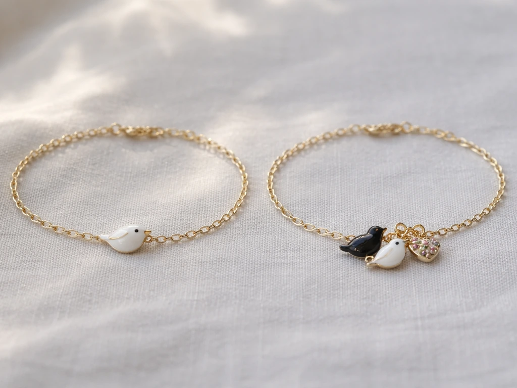 Two small bird charm bracelets side by side: one single bird charm and one grouping with birds and a floral heart
